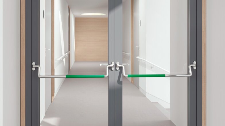 Double glass door equipped with two stainless steel panic bars with green polyamide handle tube